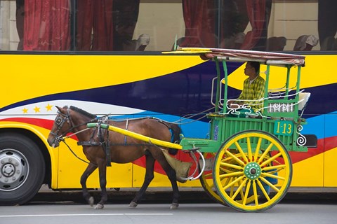Framed Horse cart walk by colorfully painted bus, Manila, Philippines Print