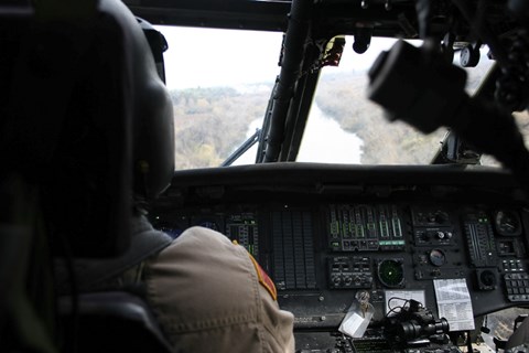 Framed UH-60 Blackhawk flies the River to an Unknown Village to Drop off a Care Package Print