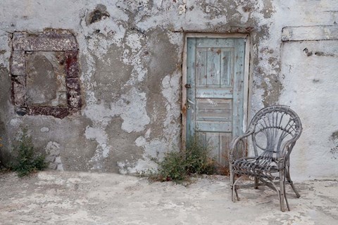 Framed Old Building chair and doorway in town of Oia, Santorini, Greece Print