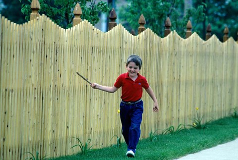 Framed 1980s Smiling Boy Running Along Sidewalk Print