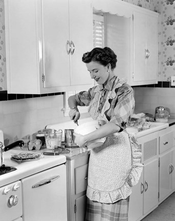 Framed 1950s Housewife In Kitchen Mixing Ingredients Print