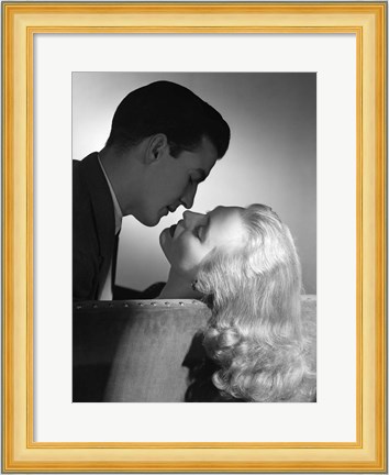 Framed Movie Star Studio Style Romantic Couple Embracing On Sofa About To Kiss Print