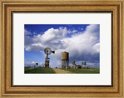 Framed Low angle view of a water tower and an industrial windmill, 1880 Town, South Dakota, USA Print