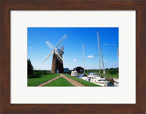 Framed Boat moored near a traditional windmill, River Ant, Norfolk Broads, Norfolk, England Print