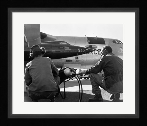 Framed Rear view of two men crouching near fighter planes, X-15 Rocket Research Airplane, B-52 Mothership Print
