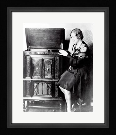 Framed Young woman sitting beside an RCA Radio-Phonograph and Home Recorder Print