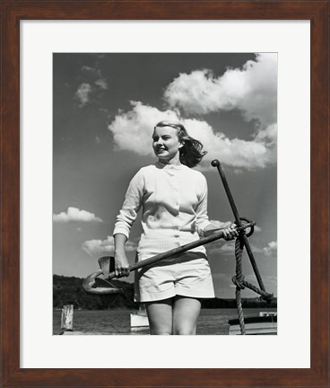Framed Young woman standing on boat, holding anchor Print