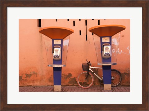 Framed Public telephone booths in front of a wall, Morocco Print