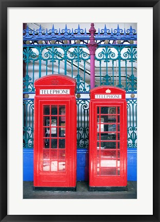 Framed Two telephone booths near a grille, London, England Print