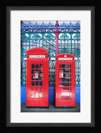 Framed Two telephone booths near a grille, London, England Print
