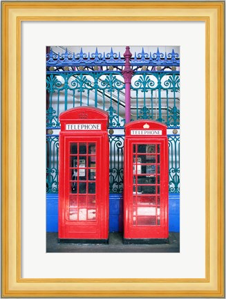 Framed Two telephone booths near a grille, London, England Print