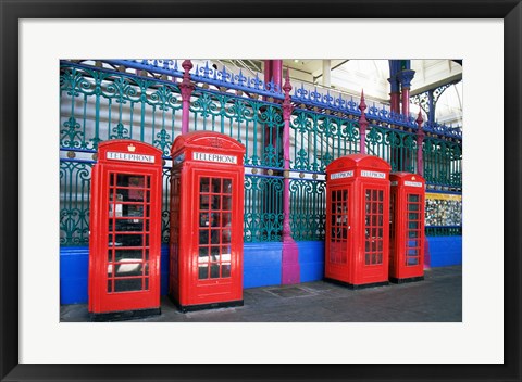 Framed Four telephone booths near a grille, London, England Print