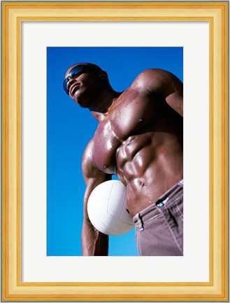 Framed Low angle view of a young man holding a volleyball Print