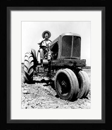 Framed Farmer Sitting on a Tractor in a Field Print