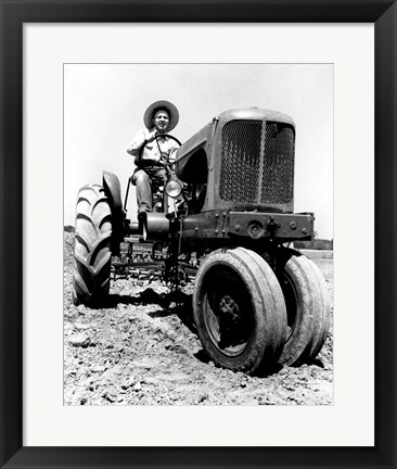 Framed Farmer Sitting on a Tractor in a Field Print