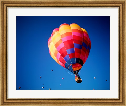 Framed Lone Hot Air Balloon with Other Hot Air Balloons in the Distance Print