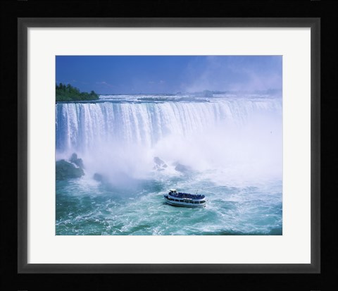 Framed High angle view of a tourboat in front of a waterfall, Niagara Falls, Ontario, Canada Print