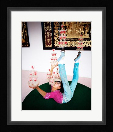 Framed Acrobat balancing glasses, Shanghai, China Print