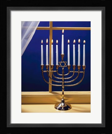 Framed Close-up of burning candles on a menorah at a window Print