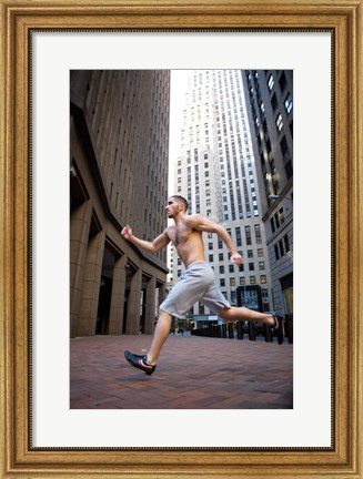 Framed Side profile of a young man running in a city Print