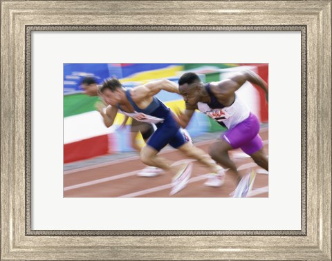 Framed Side profile of three men running low on a running track Print