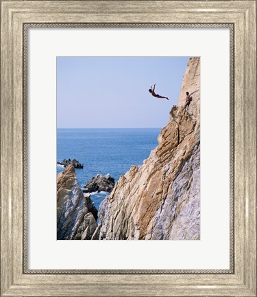 Framed Male cliff diver jumping off a cliff, La Quebrada, Acapulco, Mexico Print
