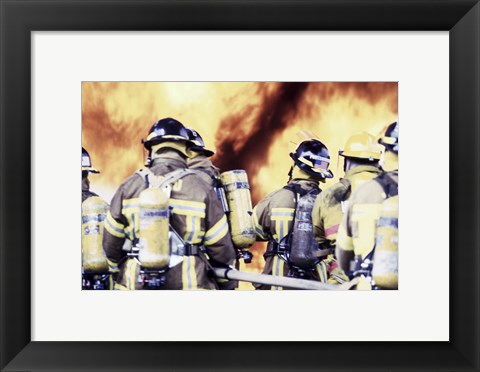 Framed Rear view of a group of firefighters holding water hoses Print