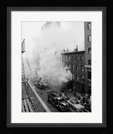 Framed New York City, Fire on East 47th Street, with fire engines shooting water on burning building Print