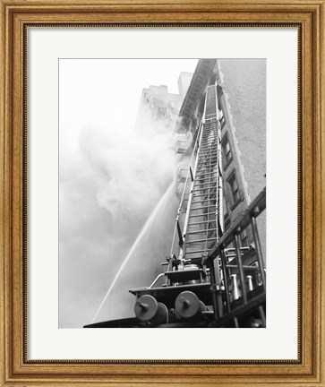 Framed Fire engine with ladder up burning building Print