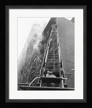 Framed Fire engine with ladder up burning building Print