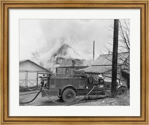Framed Fire engine next to home in fire Print