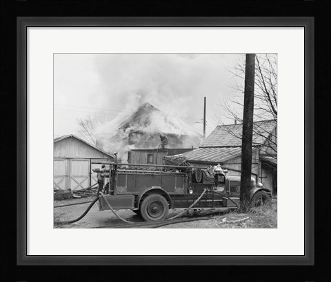 Framed Fire engine next to home in fire Print