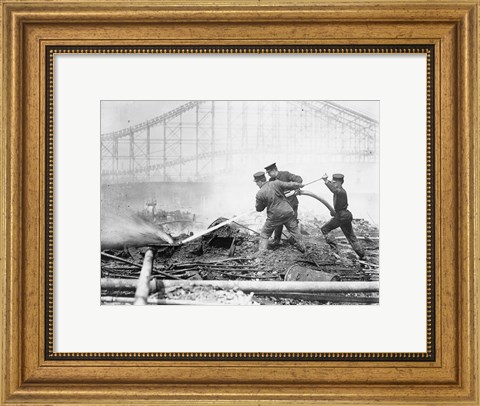 Framed Three firefighters extinguishing a fire Print