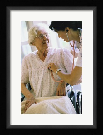Framed Female nurse checking a female patient's heartbeat Print