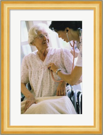 Framed Female nurse checking a female patient&#39;s heartbeat Print