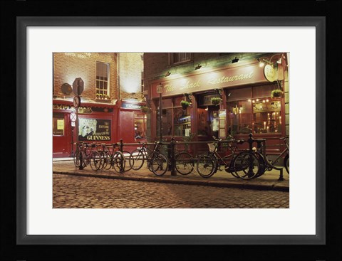 Framed Bicycles parked in front of a restaurant at night, Dublin, Ireland Print