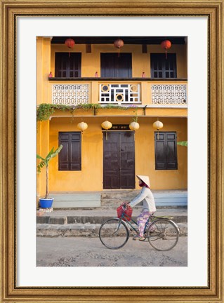 Framed Person riding a bicycle in front of a cafe, Hoi An, Vietnam Print