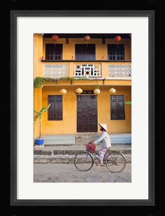 Framed Person riding a bicycle in front of a cafe, Hoi An, Vietnam Print