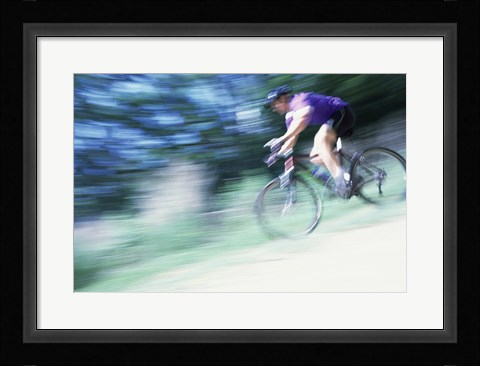 Framed Side profile of a young man riding a bicycle Print
