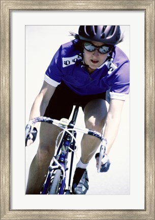 Framed Young woman riding a bicycle Print