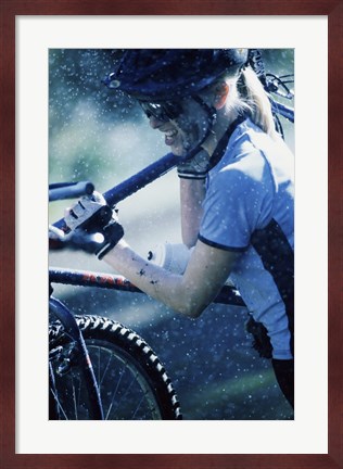 Framed Young woman carrying a bicycle on her shoulders Print