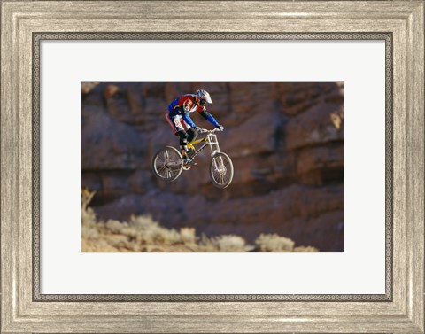 Framed Side profile of a person on a bicycle in mid air Print
