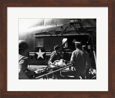 Framed Army soldiers carrying an injured person in a helicopter Print