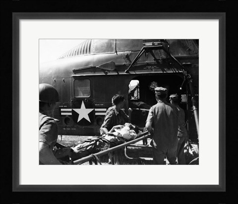 Framed Army soldiers carrying an injured person in a helicopter Print