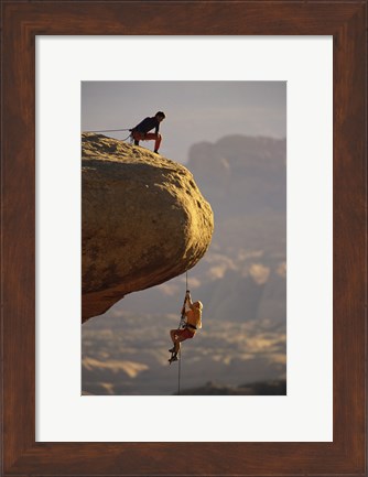 Framed View of rock climbers on the edge of a cliff Print
