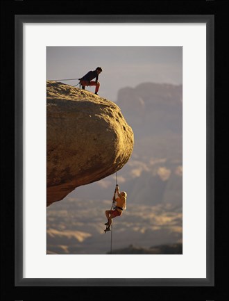 Framed View of rock climbers on the edge of a cliff Print