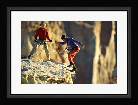 Framed Two hikers with ropes at the edge of a cliff Print