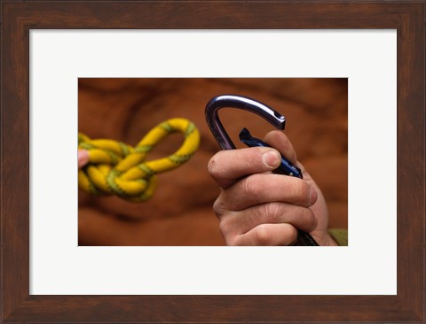 Framed Close-up of human hands holding a carabiner and rope Print