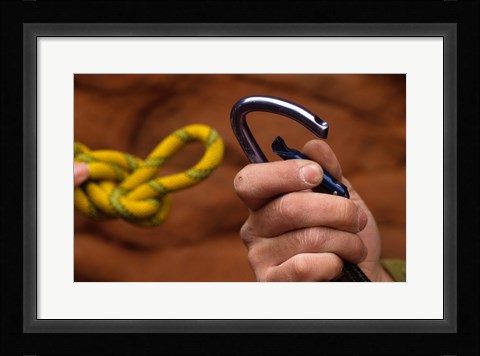 Framed Close-up of human hands holding a carabiner and rope Print