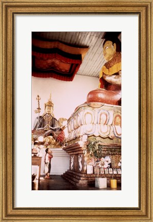 Framed Young Girl Praying in Front of a Giant Buddha Statue Print